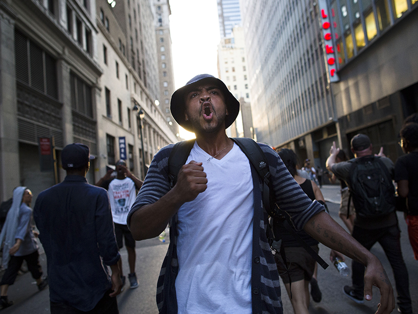 A demonstrator chants, Sunday, July 14, 2013, in New York, during a march against the acquittal of neighborhood watch member George Zimmerman in the killing of 17-year-old Trayvon Martin in Florida.  (Photo by John Minchillo/AP)