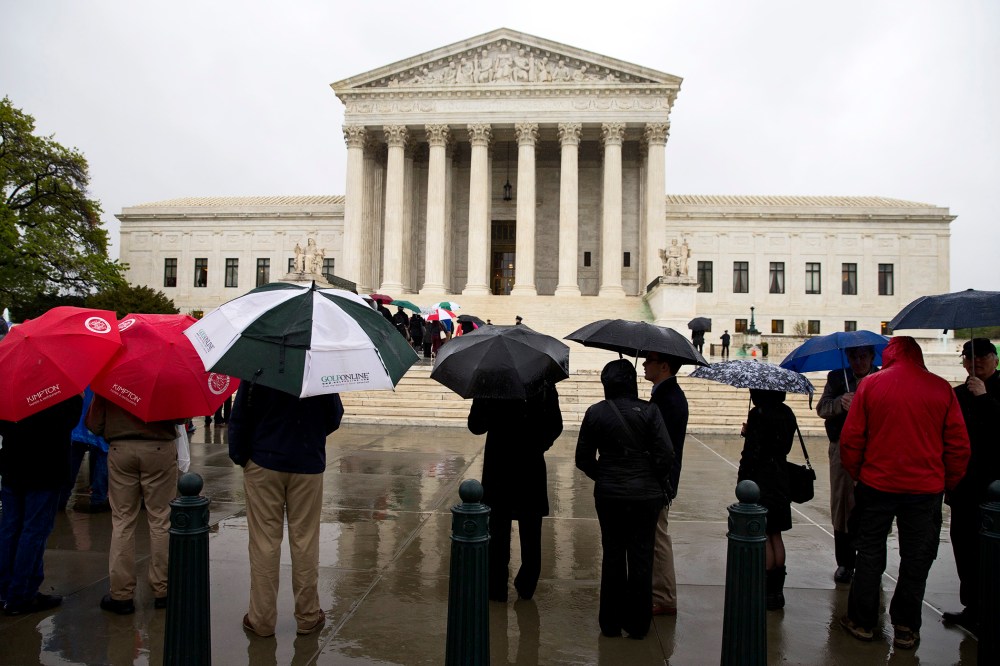 People line up outside the Supreme Court to listen to arguments, April 29, 2014, in Washington.