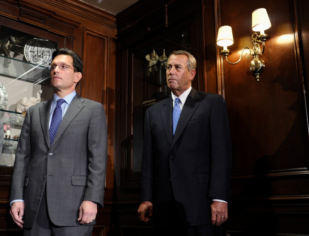House Speaker John Boehner of Ohio, center, and House Majority Leader Eric Canton of Va., left, listen during a news conference after a meeting at the Republican National Committee offices