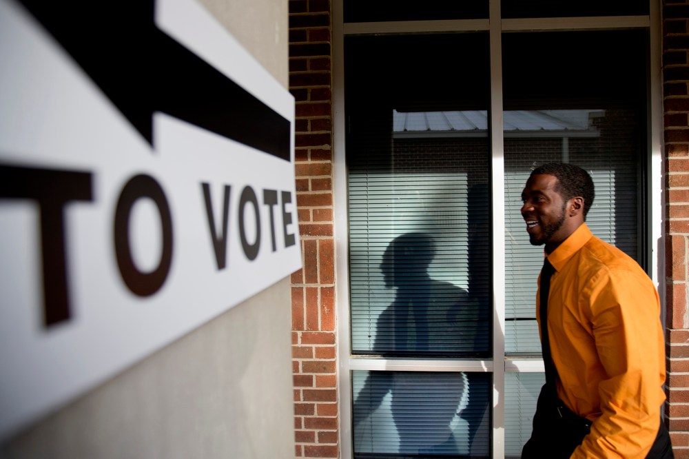 Jovan Steele, of Atlanta, enters a polling station to vote, Tuesday, Nov. 5, 2013.