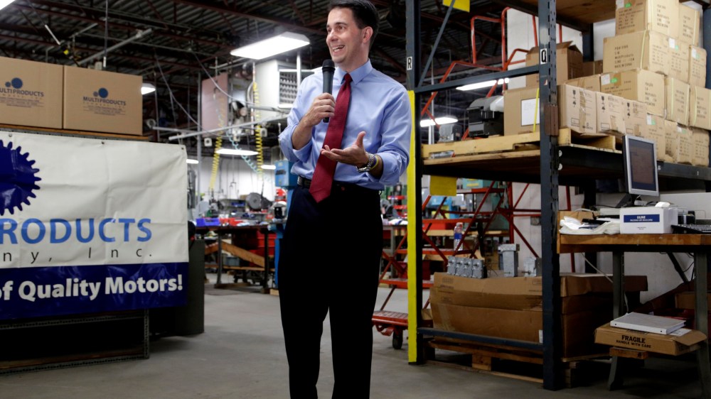 Republican Wisconsin Gov. Scott Walker campaigns for re-election at a manufacturing company in Racine, Wis. on Sept. 23, 2014.