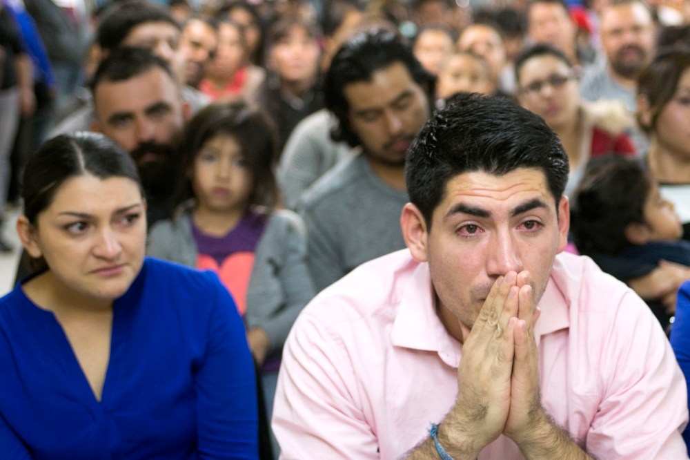 Viridiana Carrizales of San Antonio and Jose Patino, of Phoenix react during a watch party for President Obama's speech on immigration at the Puente offices in Phoenix on Nov. 20, 2014. (Photo: David Wallace/The Republic/AP)