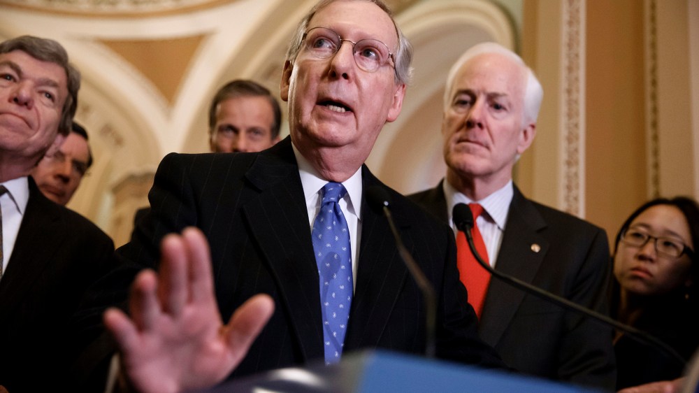 Senate Minority Leader Mitch McConnell, R-Ky., center, accompanied by fellow GOP lawmakers, speaks to reporters on Capitol Hill in Washington, Tuesday, March 25, 2014, following a GOP caucus lunch.