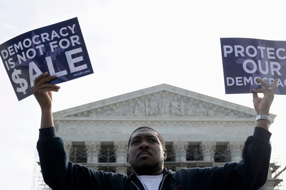 A man takes part in a demonstration outside the Supreme Court in Washington as the court heard arguments on campaign finance, Oct. 8, 2013.