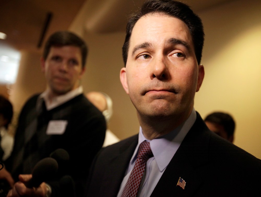 Wisconsin Gov. Scott Walker listens to a question while speaking with media about his proposed reforms to Medicaid, unemployment compensation, and food stamps, at Business Day in Madison, Wis. on Feb. 13, 2013.