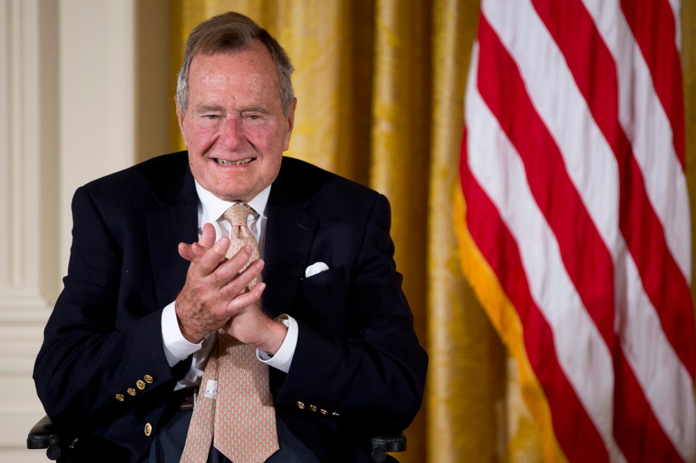 Former President George H. W. Bush applauds as he participated in a ceremony in the East Room of the White House in Washington, D.C., July 15, 2013. (Photo by Carolyn Kaster/AP)