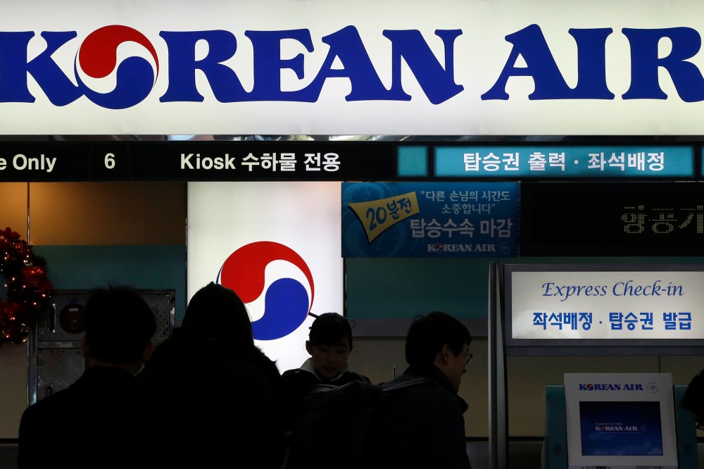 In this Dec. 16, 2014 photo, passengers wait to check in at the domestic check-in desk of Korean Air Lines Co. at Gimpo Airport in Seoul, South Korea. (Photo by Lee Jin-man/AP)