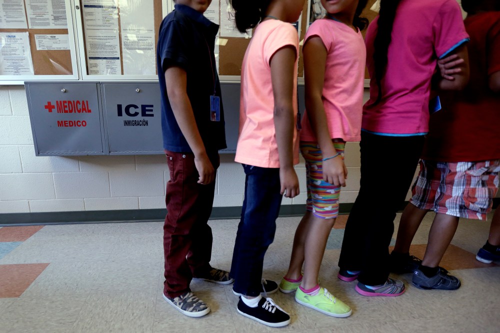 Detained immigrant children line up in the cafeteria at the Karnes County Residential Center, a temporary home for immigrant women and children detained at the border, Sept. 10, 2014, in Karnes City, Texas. (Photo by Eric Gay/AP)