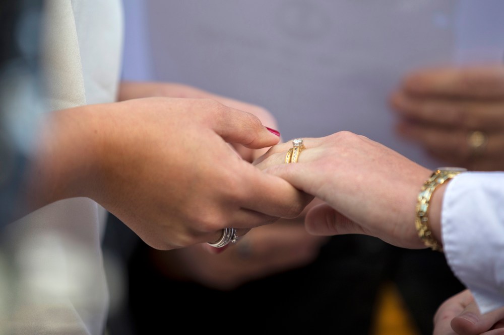 Two women hold hands after exchanging wedding rings during a ceremony. (Photo by Manuel Balce Ceneta/AP)