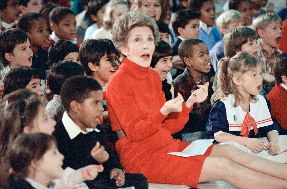 First Lady Nancy Reagan watches an anti-drug musical entitled Just Say No performed by teenage students from the Chantilly, Va., High School at the Cameron Elementary School, Feb. 26, 1987. (Photo by Scott Stewart/AP)