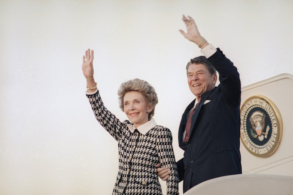 President Ronald Reagan and Mrs. Reagan wave from Air Force One at Andrews Air Force Base in evening on Sep. 8, 1986 as they return to Washington. (Photo by J. Scott Applewhite/AP)