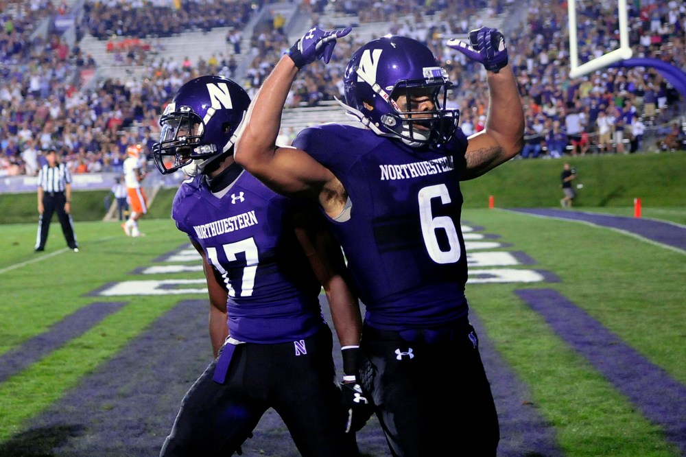 Northwestern players celebrate a touchdown during a game against Syracuse University in Evanston, Ill, Sept.7, 2013.