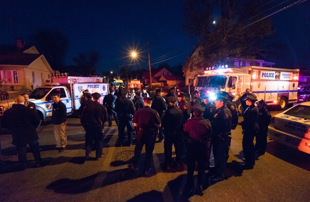 Police work in a neighborhood in the Queens borough of New York on May 2, 2015 after an NYPD officer was shot. He was taken to Jamaica Hospital Medical Center in Queens. (Photo by Craig Ruttle/AP)