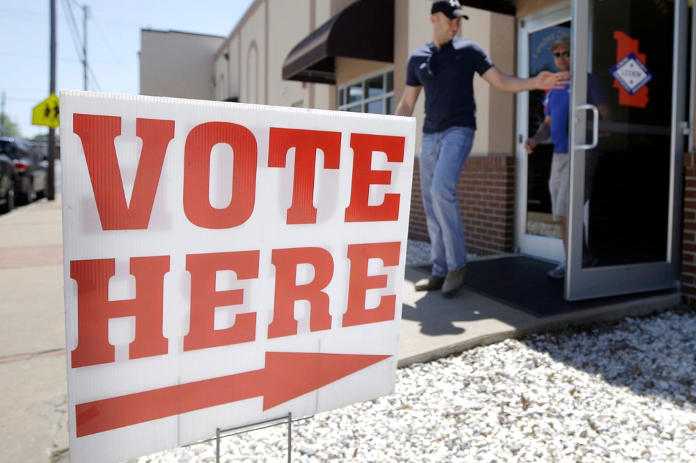 Trey Petrus of Carlisle, Ark., leaves an early voting poling place in Lonoke, Ark., May 5, 2014.