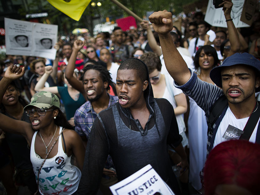 Crowds of demonstrators prepare to march towards Times Square, Sunday, July 14, 2013, during a protest against the acquittal of neighborhood watch member George Zimmerman in the killing of 17-year-old Trayvon Martin in Florida. (Photo by John Minchillo...