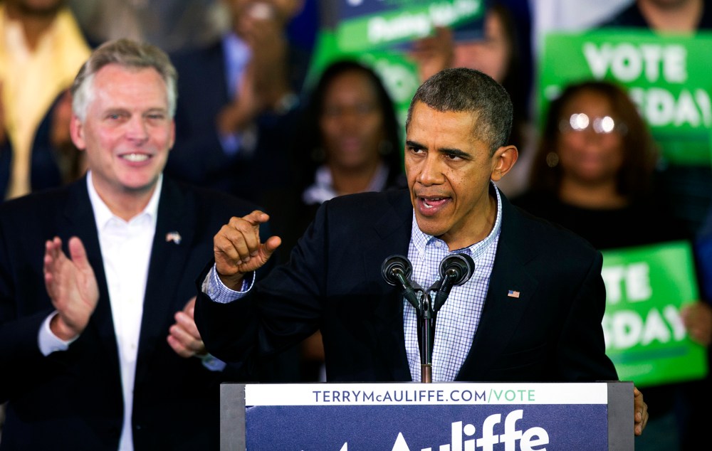 President Barack Obama speaks at a campaign rally with supporters for Virginia Democratic gubernatorial candidate Terry McAuliffe, right, at Washington Lee High School in Arlington, Va., Sunday, Nov. 3, 2013.
