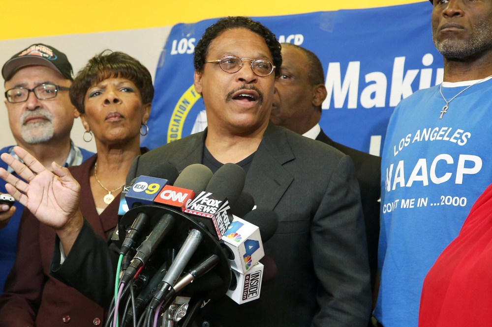 Leon Jenkins, center, president of the Los Angeles chapter of the NAACP speaks at a news conference in Culver City, Calif., April 28, 2014.