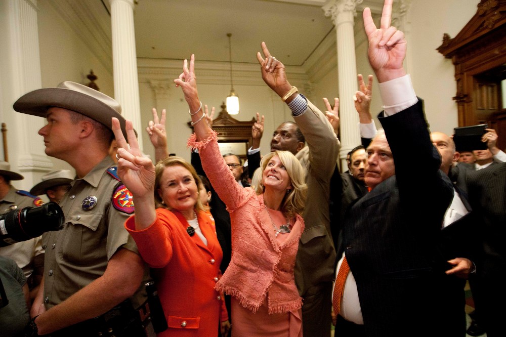 State Senators, from second left, Sylvia R. Garcia, D-Houston, Wendy Davis, D-Fort Worth, Royce West, D-Dallas, Kirk Watson, D-Austin, and John Whitmire, D-Houston, greet abortion rights advocates to show they voted against HB2, which the Senate approved
