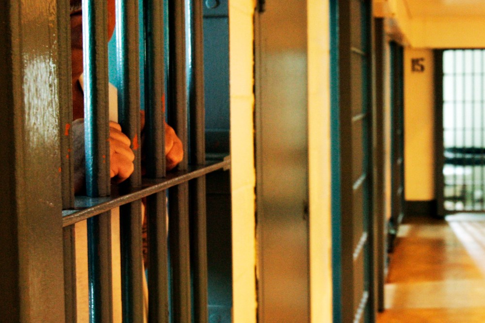 An inmate stands by his cell door. (Photo by Danny Johnston/AP)