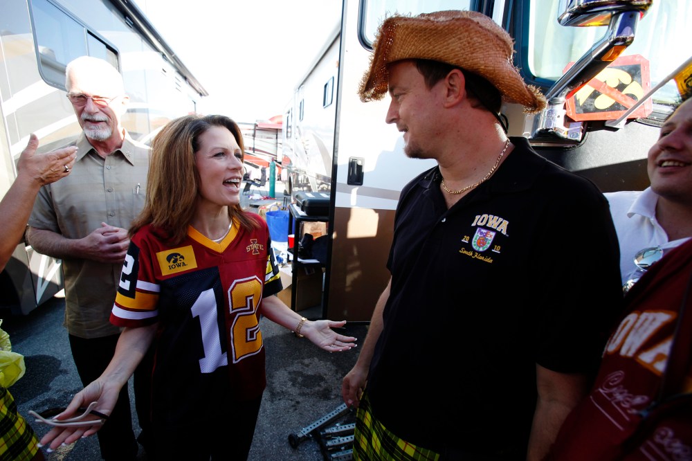 Former U.S. Rep. Michele Bachmann talks with Mark Chelgren of Ottumwa, Iowa, while tailgating before an NCAA college football game between Iowa State and Iowa, Sept. 10, 2011, in Ames, Iowa. (Photo by Charlie Neibergall/AP)