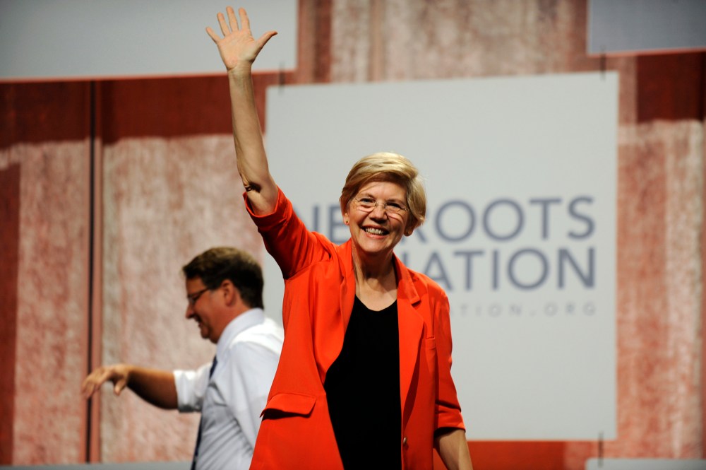 U.S. Sen. Elizabeth Warren, D-Mass., waves to the crowd after her introduction at the Netroots Nation conference in Detroit (Photo by David Coates/AP).