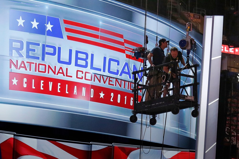The main stage on the convention floor at the Quicken Loans Arena in downtown Cleveland, Ohio, is prepared for the upcoming RNC, as workers stand in a man lift, July 13, 2016. (Photo by Gene J. Puskar/AP)