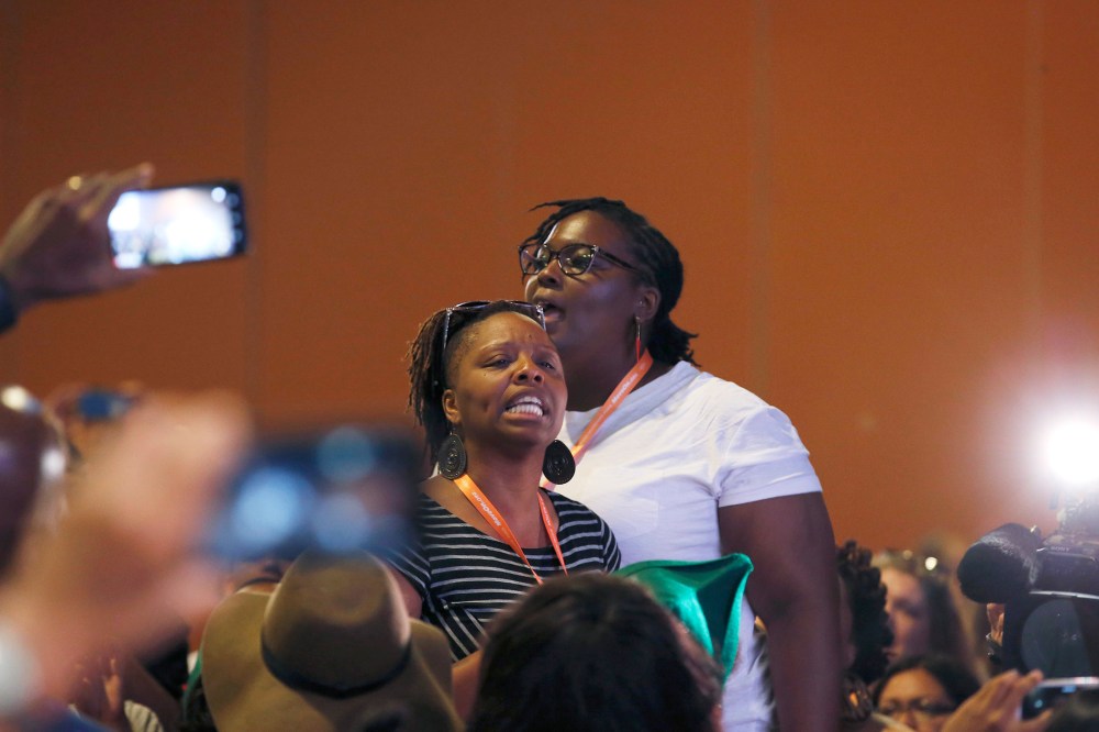 Black Lives Matter and Black Immigration Network activists shout down the first of two Democratic presidential candidates speakers at a Netroots Nation town hall meeting on July 18, 2015, in Phoenix, Ariz. (Photo by Ross D. Franklin/AP)