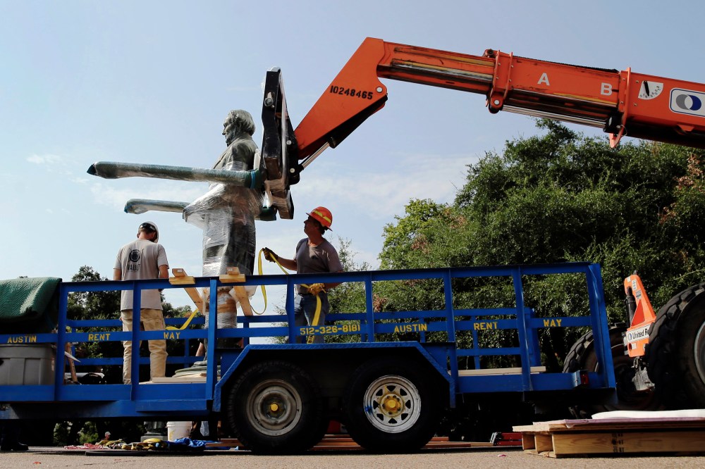 A statue of Confederate President Jefferson Davis is moved from its location in front of the school's main tower the University of Texas campus, Sunday, Aug. 30, 2015, in Austin, Texas. (Photo by Eric Gay/AP)
