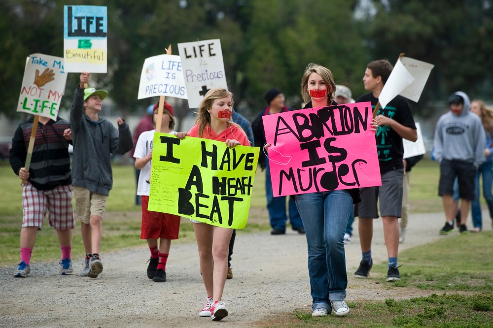 Pro-life protesters attend an annual Walk for Life, held by the Porterville Pregnancy Center Saturday, April 5, 2014 in Porterville, Calif. (Photo by Chieko Hara/The Porterville Recorder/AP)