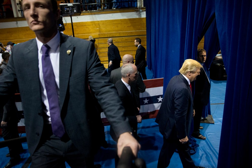 Republican presidential candidate Donald Trump, right, smiles as leaves the gym after a rally, Jan. 12, 2016, in Cedar Falls, Iowa. (Photo by Jae C. Hong/AP)