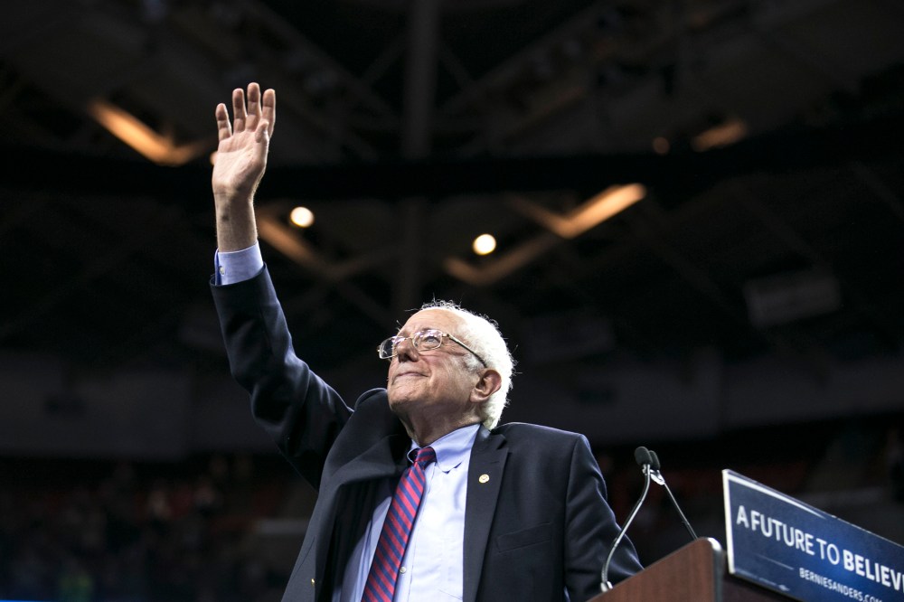 Democratic presidential candidate Sen. Bernie Sanders, I-Vt., waves to the crowd after speaking on March 20, 2016, at a campaign rally in Seattle, Wash. (Photo by Stephen Brashear/AP)
