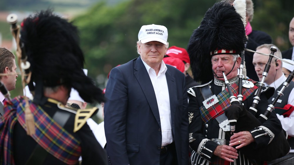 The presumptive Republican presidential nominee Donald Trump poses with a bagpiper as he arrives at his revamped Trump Turnberry golf course in Turnberry Scotland, June 24, 2016. (Photo by Andrew Milligan/PA/AP)