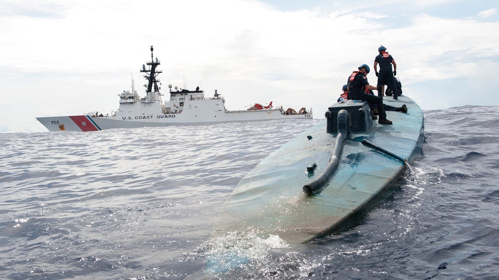 In this July 19, 2015 photo released by the U.S. Coast Guard, a Coast Guard Cutter Stratton boarding team investigates a self-propelled semi-submersible. (Photo by LaNola Stone/U.S. Coast Guard/ AP)