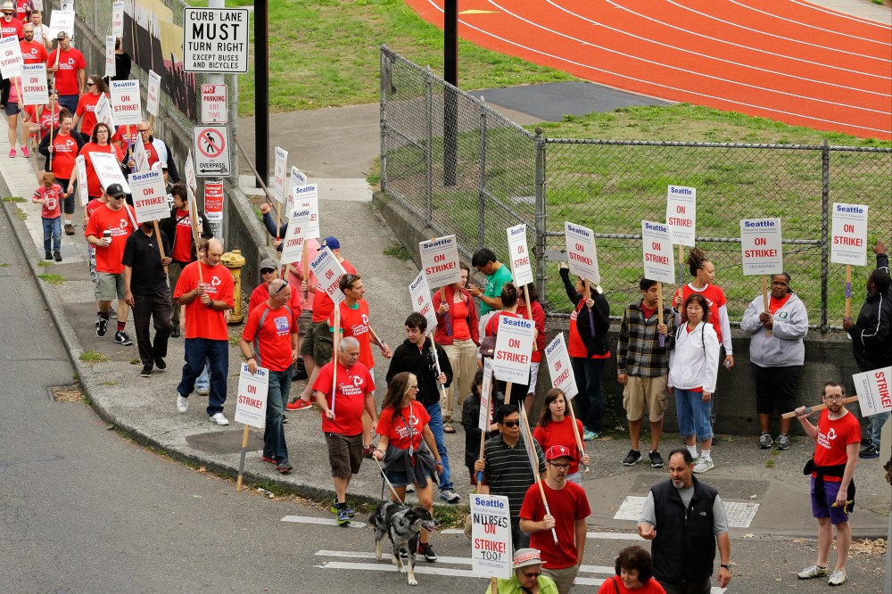 Striking Seattle School District teachers and other educators walk a picket line, Thursday, Sept. 10, 2015, near Franklin High School in Seattle. (Photo by Ted S. Warren/AP)