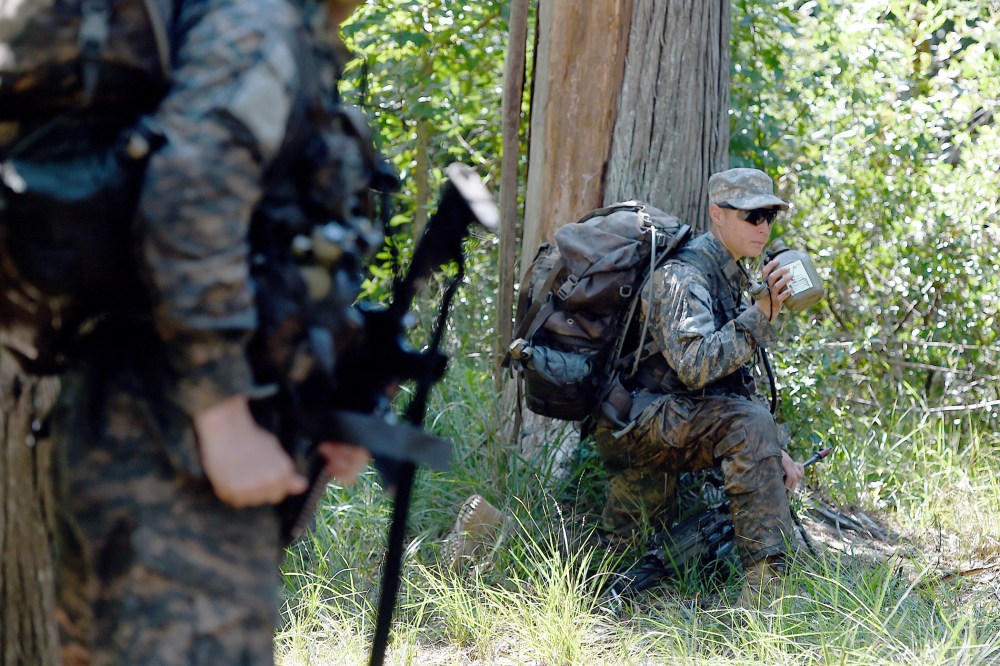 A female Ranger student holds a position with her team during an exercise on Aug. 4, 2015, at Camp James E. Rudder on Eglin Air Force Base, Fla. (Photo by Nick Tomecek/Northwest Florida Daily News/AP)