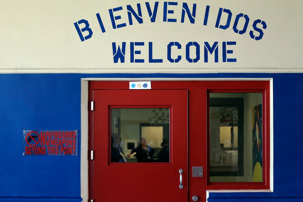 A Spanish and English welcome sign is seen above a door in a secured entrance area at the Karnes County Residential Center in Karnes City, Texas on Jul. 31, 2014.