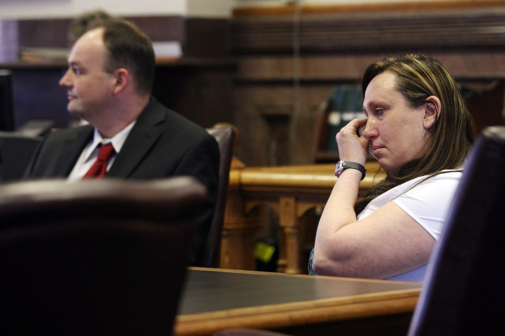 Kelli Jo Griffin, Montrose, Iowa, wipes away tears as she listens with her attorney to a not guilty verdict, March 20, 2014 in Keokuk, Iowa. (Photo by John Gaines/The Hawk Eye/AP)