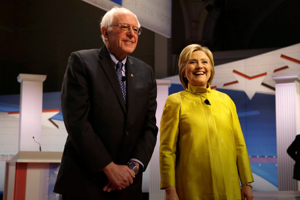 Democratic presidential candidates Sen. Bernie Sanders and Hillary Clinton smile as they take the stage before a Democratic debate, Feb. 11, 2016, in Milwaukee, Wis. (Photo by Tom Lynn/AP)