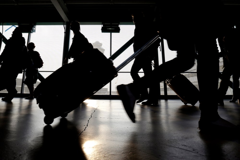 Travelers walk through O'Hare International airport in Chicago, Ill. (Photo by Nam Y. Huh/AP)