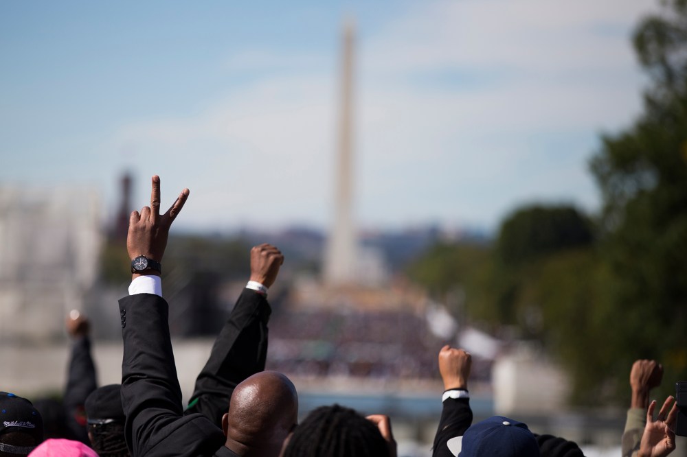 People put their hands in the air during a rally to mark the 20th anniversary of the Million Man March, on Capitol Hill, on Oct. 10, 2015, in Washington. (Photo by Evan Vucci/AP)