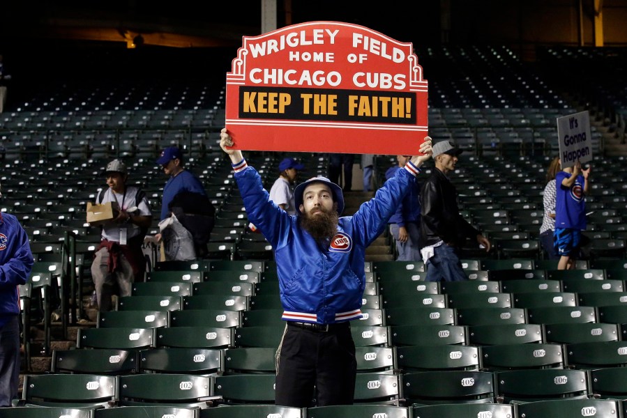 A Chicago Cubs fan holds up a sign after Game 4 of the National League baseball championship series against the New York Mets, Oct. 21, 2015, in Chicago. (Photo by Nam Y. Huh/AP)