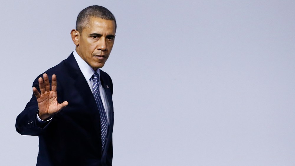 US President Barack Obama walks offstage during the 'Mission Innovation: Accelerating the Clean Energy Revolution' meeting at the COP2 in Le Bourget, France, Nov. 30 2015. (Photo by Ian Langsdon/Pool/AP)