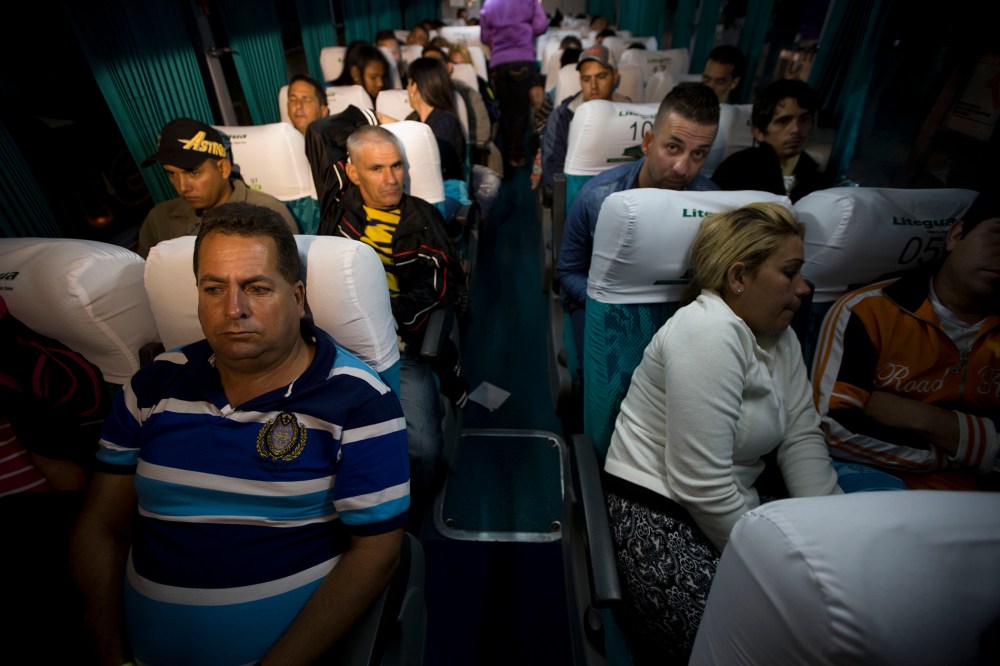 Cuban migrants wait on a bus in Ciudad Pedro De Alvarado, Guatemala, at the border with El Salvador, Jan. 13, 2016, as they continue on their journey to the United States. (Photo by Moises Castillo/AP)