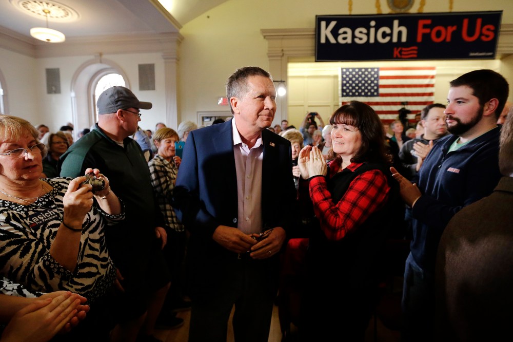 Republican presidential candidate, Ohio Gov. John Kasich, center, arrives at the start of a town hall campaign event, Feb. 29, 2016, in Plymouth, Mass. (Photo by Steven Senne/AP)