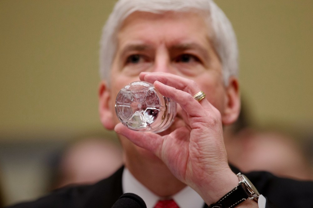 Michigan Gov. Rick Snyder drinks water as he testifies before a House Oversight and Government Reform Committee hearing in Washington, March 17, 2016. (Photo by Andrew Harnik/AP)