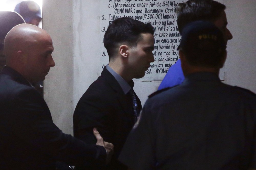U.S. Marine Lance Cpl. Joseph Scott Pemberton, center, is escorted inside a court in Olongapo city, Philippines on Dec. 1, 2015. (Photo by Aaron Favila/AP)