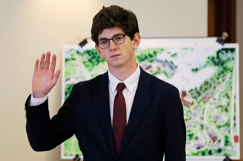 Former St. Paul's School student Owen Labrie raises his hand as he is sworn-in prior to testifying in his trial at Merrimack Superior Court in Concord, N.H., Wednesday, Aug. 26, 2015. (Photo by Charles Krupa/AP)