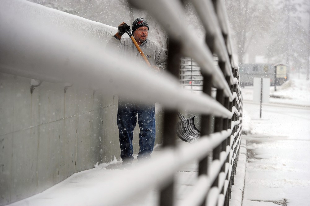 Dan Schumacher clears off the sidewalk outside of the Sioux Falls, VA Medical Center in Sioux Falls, S.D., Nov. 30, 2015. (Photo by Jay Pickthorn/The Argus Leader/AP)