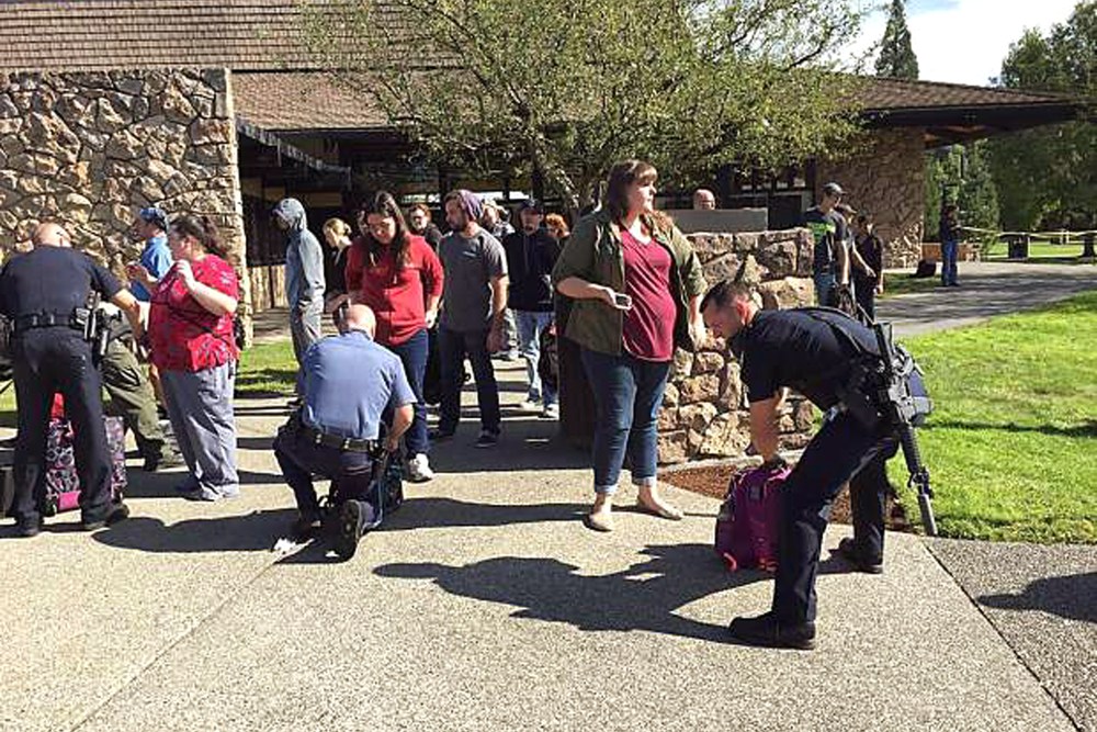 Police search students outside Umpqua Community College in Roseburg, Ore., Oct. 1, 2015, following a deadly shooting at the southwestern Oregon community college. (Photo by Mike Sullivan/Roseburg News-Review/AP)