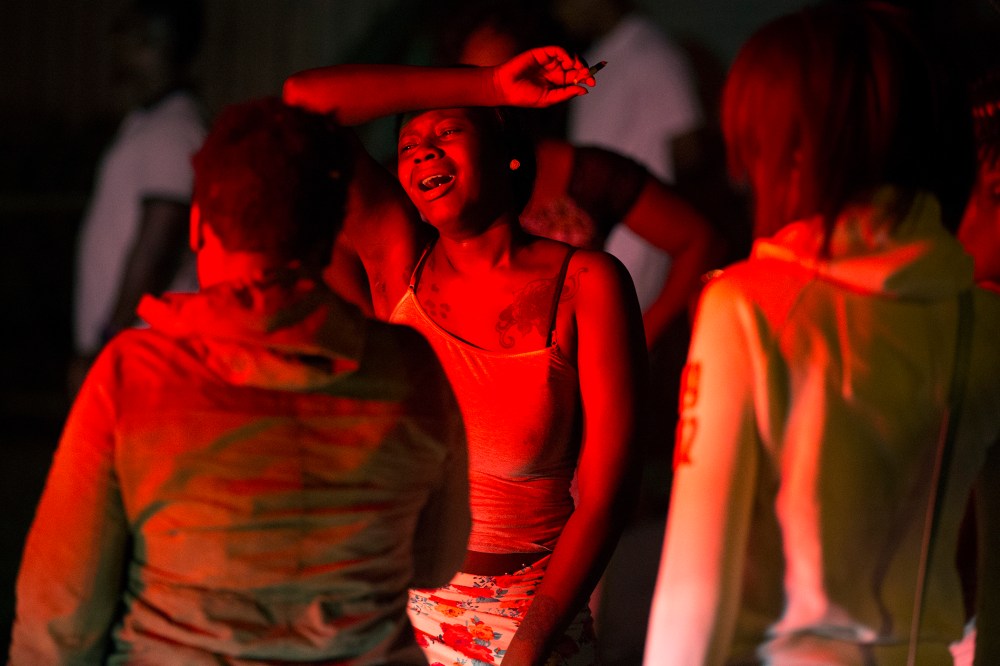 A woman cries at the Boys and Girls Club, early on Aug. 20, 2015, in Rochester, N.Y., where a gunman shot into a crowd gathered outside after a basketball game, fatally wounding several people. (Photo by Lauren Petracca/Democrat & Chronicle/AP)
